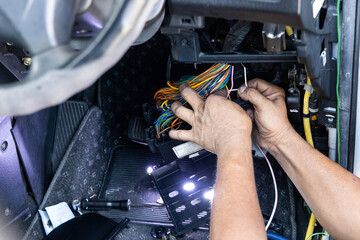 Auto technician diagnose and fixing wiring problem of car