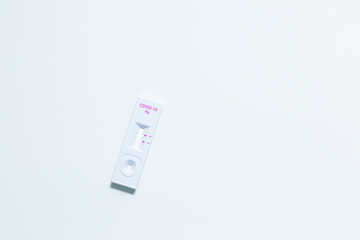 Rapid antigen self test kit for Covid-19 diagnostic at home with nasal swabs, tubes, detection device and a ffp-2 face mask, light gray background, copy space, view from above, selected focus