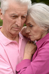 Portrait of sad senior couple in the park