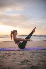 Foto op Plexiglas Woman doing boat yoga pose on the beach © Jacob Lund