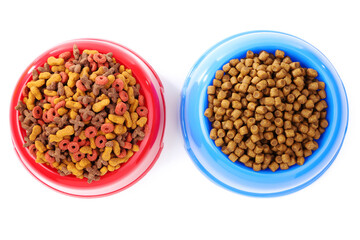 Dry pet food in bowls isolated on white background