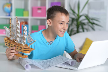 Portrait of a boy with a homemade toy-ship