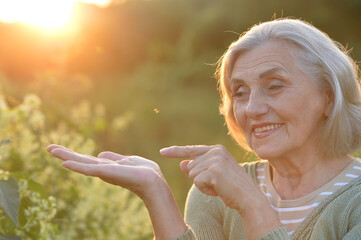 happy smiling senior woman outdoors gesturing