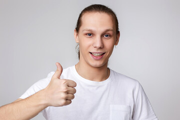 young handsome man in t-tshirt showing Ok gesture