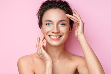 Beautiful woman with perfect skin on pink background. Beauty and skin care concept