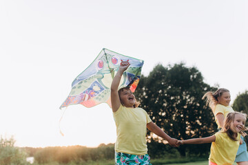Cheerful kids playing together outdoors in countryside 
