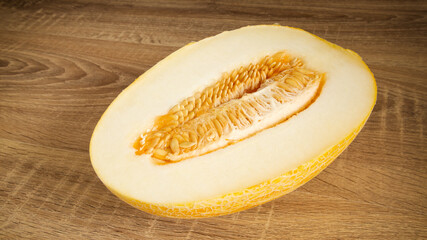 Juicy yellow melon on a wooden table - 45 degree view
