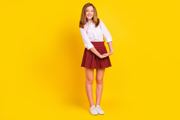 Full length photo of cute small girl hold hands wear shirt skirt bag sneakers isolated on yellow background - obrazy, fototapety, plakaty