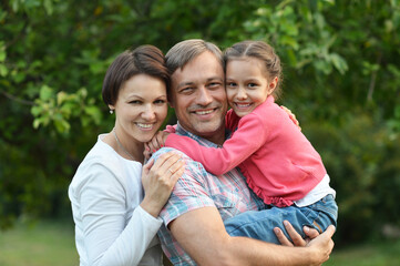 happy family with her daughter in the park