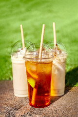 Summer drinks in plastic glasses with a lid and straws. Take away. Concept. Poster. Photo