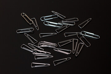 Paper clips on the black background.