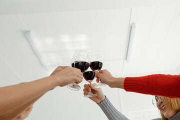young asian people cheering red wine enjoy party in office,