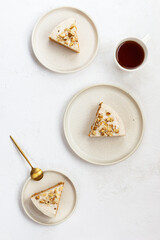 Pieces of carrot cake with walnuts and a cup of coffee. Vertical orientation, top view.