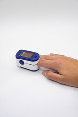 Hand using oximeter on index finger