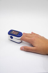 Hand using oximeter on index finger