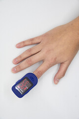 Hand using oximeter on index finger
