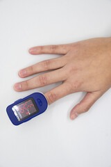 Hand using oximeter on index finger