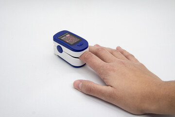 Hand using oximeter on index finger