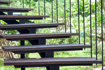 Wood stairs with steel handrail in the outdoor garden.