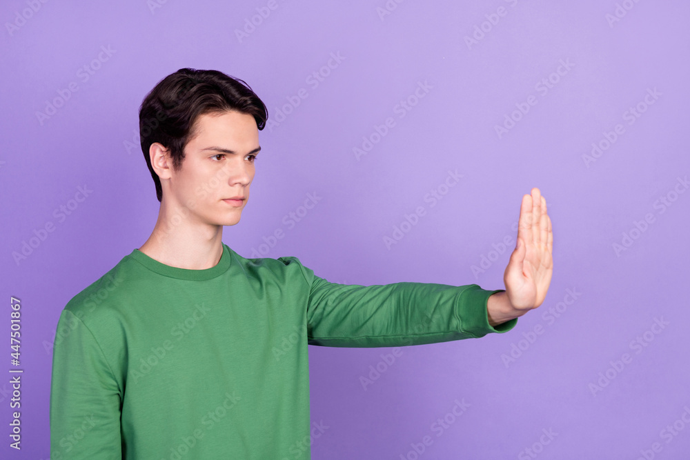 Sticker Profile side photo of young guy look empty space hold hand stop sign prohibition warning isolated over violet color background