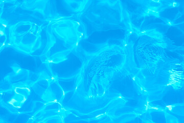 Blue water surface in the pool with the glare of the sun.Creative background,top view.