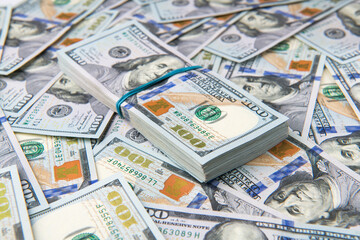 Obraz na płótnie Canvas Stack of one hundred dollar bills close-up.