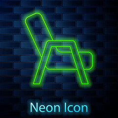 Glowing neon line Armchair icon isolated on brick wall background. Vector