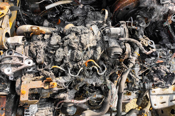 Burned-out car after arson accident. Melted plastic in a fire.