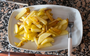 French fries on dish with a fork