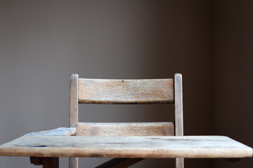 vintage wood school desk with neutral background and copy space