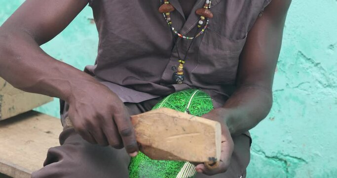 Wood carver chisel colorful statue Accra Ghana Africa. Hand tool make work difficult and unique craftsmanship. Tourism, business and home decorations. Handmade product. Products sell in street.