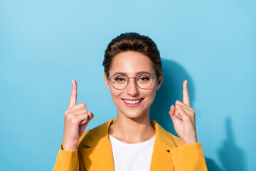 Photo portrait woman in yellow blazer spectacles showing fingers up blank space isolated pastel blue color background