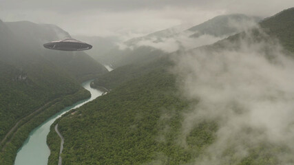Flying Saucer over Europe mountains and river,aerial
alien invasion Concept in Europe forest...