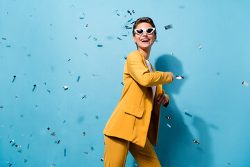 Portrait of attractive cheerful woman having fun dancing seuins flying festive event isolated over...