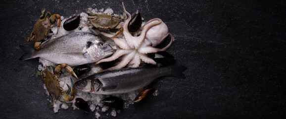 plate of raw seafood on ice, sea bass, cuttlefish, blue crabs and dorado, panoramic mock-up image