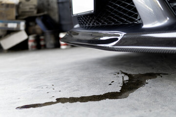 Engine oil stains of car Leak under the car when the car is park on the road  service photo concept...