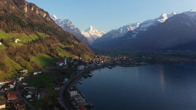 Aerial drone footage of the Fluelen village on the Saint Gotthard road and lake Lucerne in Canton Uri in the alps in Central Switzerland in summer