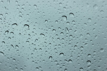 Water​ rain​ drops​ on​ glass​ background.​ Rain​ drops​ on​ a​ Windows.