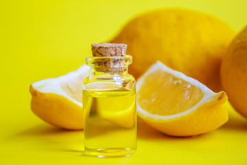 lemon essential oil on a yellow background. Selective focus.
