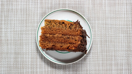 One piece of chocolate cake is lying on a plate