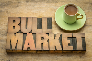 bull market word abstract in letterpress wood type with a cup of coffee, market that is on the rise and where the conditions of the economy are generally favorable