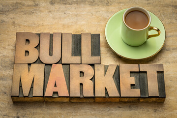 bull market word abstract in letterpress wood type with a cup of coffee, market that is on the rise...