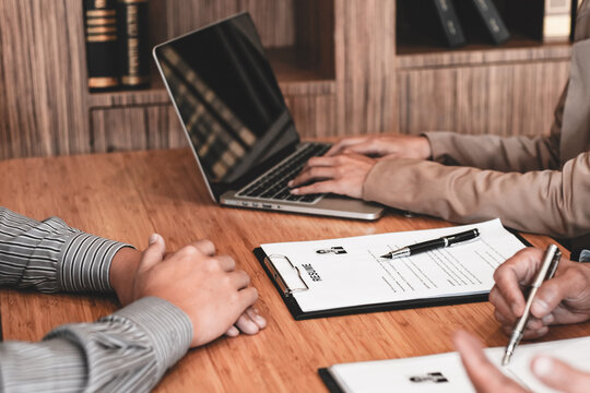 Examiner reading a resume during job interview at office Business and human resources concept