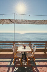 Promenade with tables and chairs overlooking the sea