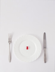 Red gummy bear served on plate. minimal creative concept on  white background.
