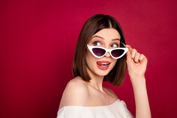 Naklejka premium Photo portrait pretty brunette wearing sunglass licking lips looking copyspace isolated red color background