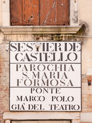 signage Sestiere Castello - castle quarter - Parochina S. Maria Formosa - holy Mary Place - , Ponte Marco Polo Gia del Teatro - bridge of Marco Polo and way to theater - at old housewall in Venice
