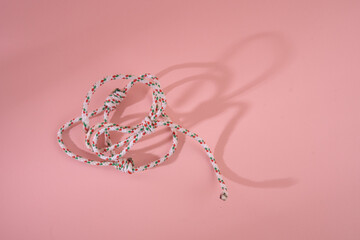 Rope and knot on pink background
