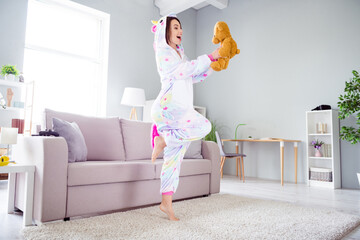 Photo of positive excited inspired dancer lady dance hold fluffy bear wear unicorn cosplay kigurumi...