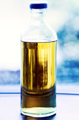 Clear glass bottle with yellow liquid